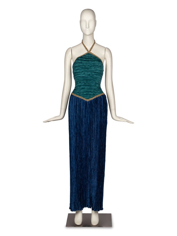 Mary McFadden Pleated Halter Gown: Mary McFadden Pleated Halter Gown Column gown in teal and royal blue plissé fabric. Gold-tone lamé trim throughout. Sleeveless halter neckline. Boning at sides of bodice. Keyhole cutout at
