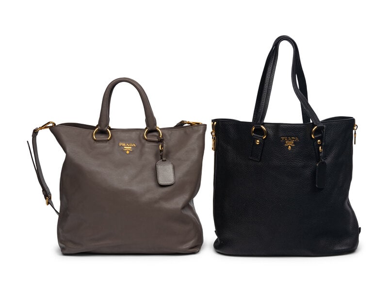 Two Prada Leather Totes: Two Prada Leather Totes THE FIRST Tote Bag in Taupe Leather with Gold-Tone Hardware. Label: Prada Date: 2010's Country of Origin: Italy Approximate Dimensions 17" W x 14" H
