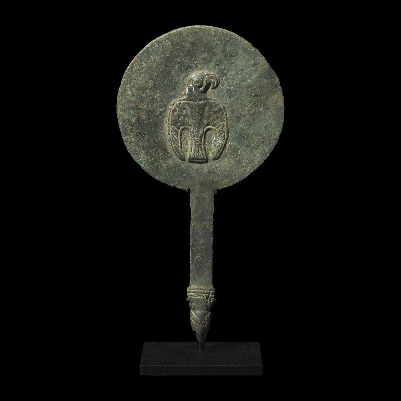 A Byzantine Bronze Mirror with an Eagle: A Byzantine Bronze Mirror with an Eagle Circa 6th-7th Century A.D. Height 7 7/8 inches (20 cm). Size Height 7 7/8 inches (20 cm). Condition Height with stand 8 1/2 inche