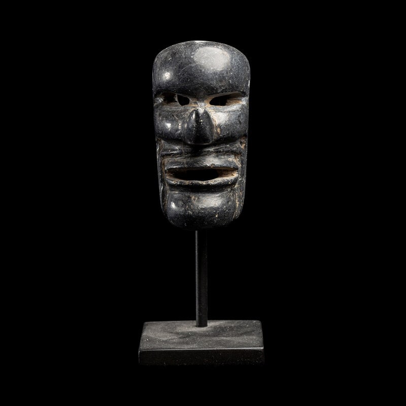 A Maya Stone Mask: A Maya Stone Mask Circa 600-900 A.D. or Later Height 2 1/2 inches (6.35 cm). Size Height 2 1/2 inches (6.35 cm). Condition Height with stand 4 1/8 inches (10.48 cm).