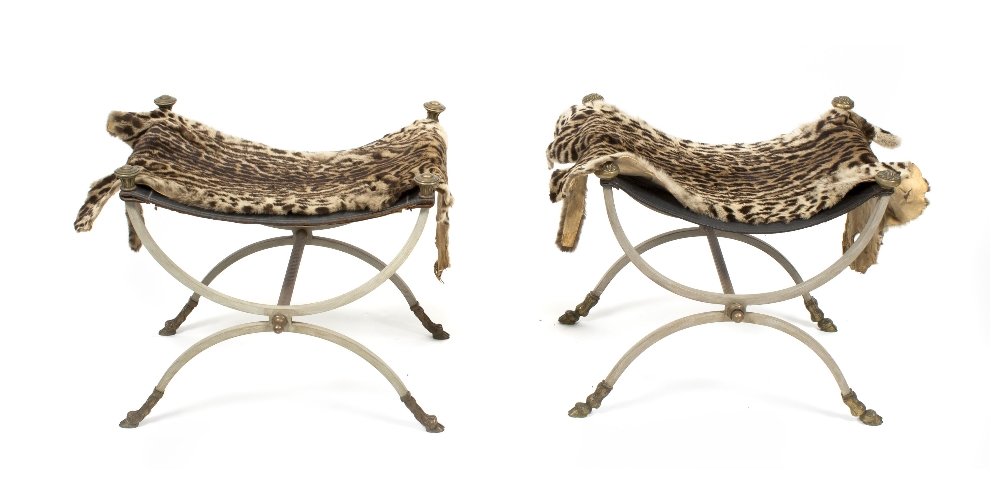 A Near Pair of Neoclassical Style Painted Wrought I: A Near Pair of Neoclassical Style Painted Wrought Iron Curule Stools, the leather seat having bronze finials to each corner, over the frame terminating in hoof feet, together with a pair of ocelot pel