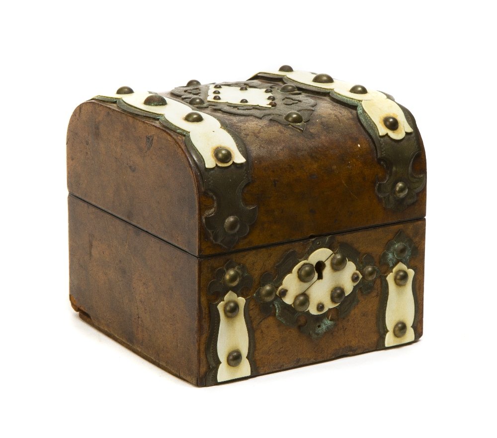 An English Burlwood and Ivory Mounted Table Casket,: An English Burlwood and Ivory Mounted Table Casket, of square form, the hinged dome lid having a central cartouche flanked by two linear bands of mounted metal with ivory accents and nailhead fastener