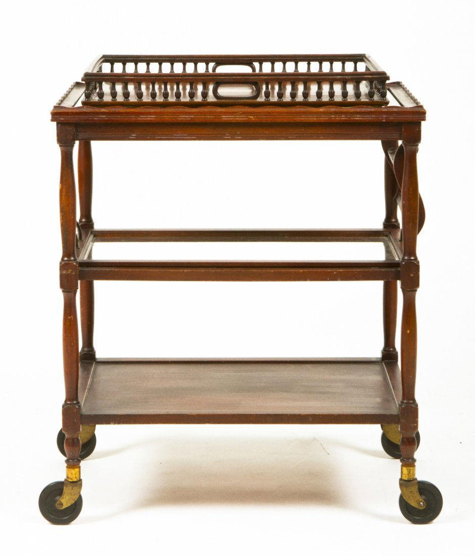 An American Three-Tiered Tea Cart, Height overall: An American Three-Tiered Tea Cart, the rectangular galleried top over the central tier having a removable glass tray, raised on casters, together with an associated serving tray. Height overall 31 x w