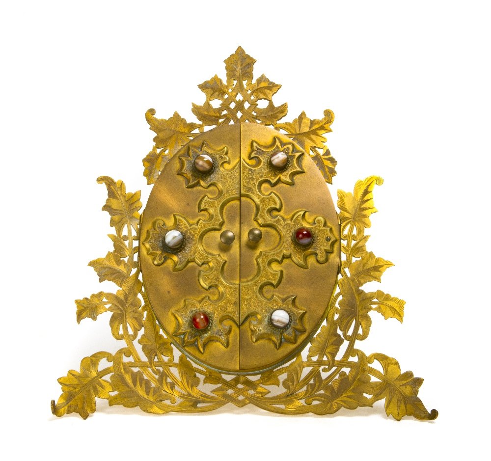 An English Polished Stone Inset Brass Frame, Howel: An English Polished Stone Inset Brass Frame, Howell James & Co., of triangular form, with leaf decoration, opening to an oval form, marked Howell, James & Co., Regent Street London. Height 9 1/2 x wid