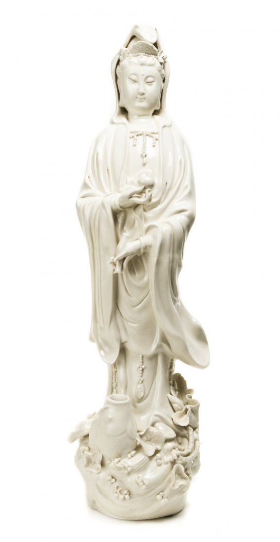 A Chinese Blanc de Chine Figure of Guanyin, Height: A Chinese Blanc de Chine Figure of Guanyin, depicted bearing her traditional attributes. Height 20 3/4 inches. Property from the Estate of Norman Frost, Naples, Florida