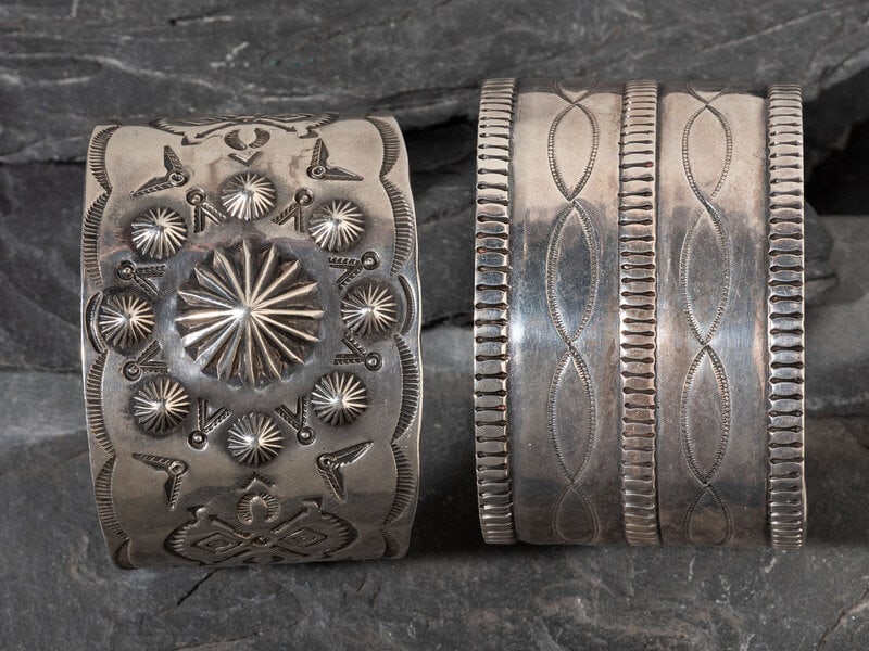 Pair of Navajo Stamped Silver Cuff Bracelets: Pair of Navajo Stamped Silver Cuff Bracelets mid-20th century lot of 2, both not marked, sizes include: cuff width 1-3/4 inches, interior circumference 5-3/4 inches + gap length 1-3/8 inches, w