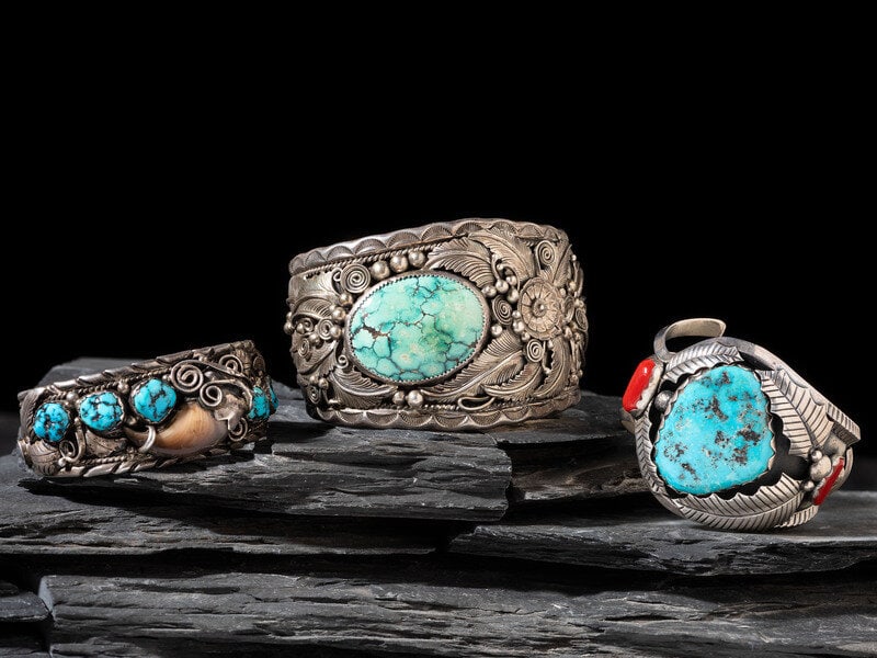 Navajo Cuff Bracelets: Navajo Cuff Bracelets third quarter 20th century lot of 3, includes: a large example set with a turquoise cabochon; marked TOM LEWIS STERLING cuff width 2-1/4 inches, interior cir