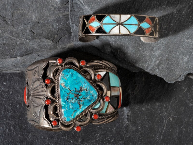 Navajo Inlaid Silver Cuff Bracelets: Navajo Inlaid Silver Cuff Bracelets third quarter 20th century lot of 2, includes: a wide cuff set with a central turquoise stone accented by smaller coral cabochons; features a tapered shank,