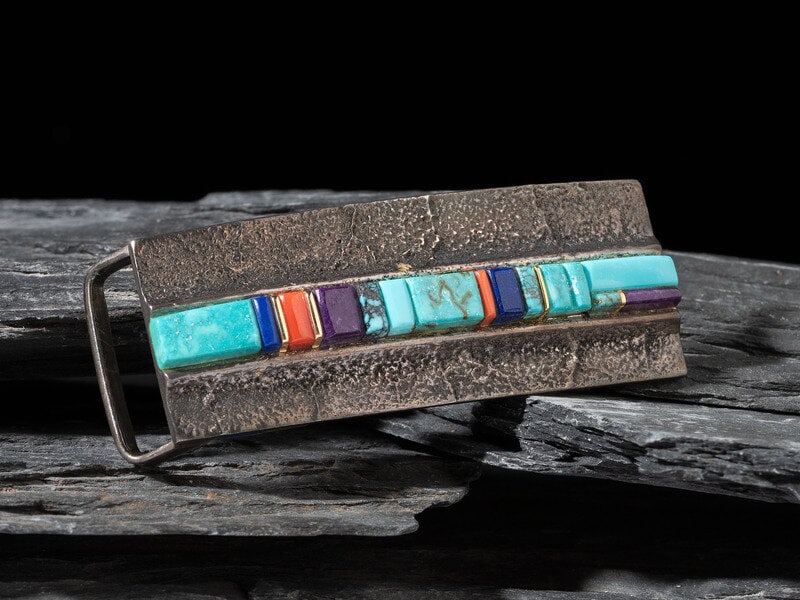 Verma Nequatewa, Sonwai (Hopi, b. 1949) Tufa Cast Silver and Cobbelstone Inlay Belt Buckle, with Gol: Verma Nequatewa, Sonwai (Hopi, b. 1949) Tufa Cast Silver and Cobbelstone Inlay Belt Buckle, with Gold Accents signed SONWAI height 1-1/4 inches x width 3 inches, belt width 1 inch, weight 25.8 dwt. T