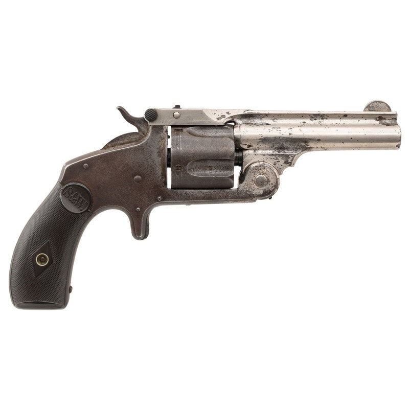 Smith & Wesson .38 Single Action Second Model: Smith & Wesson .38 Single Action Second Model .38 S&W. 3.25. SN: 6901. Nickel plated finish with blued small parts mounting S&W initial checkered hardrubber grips and pinned half moon fron