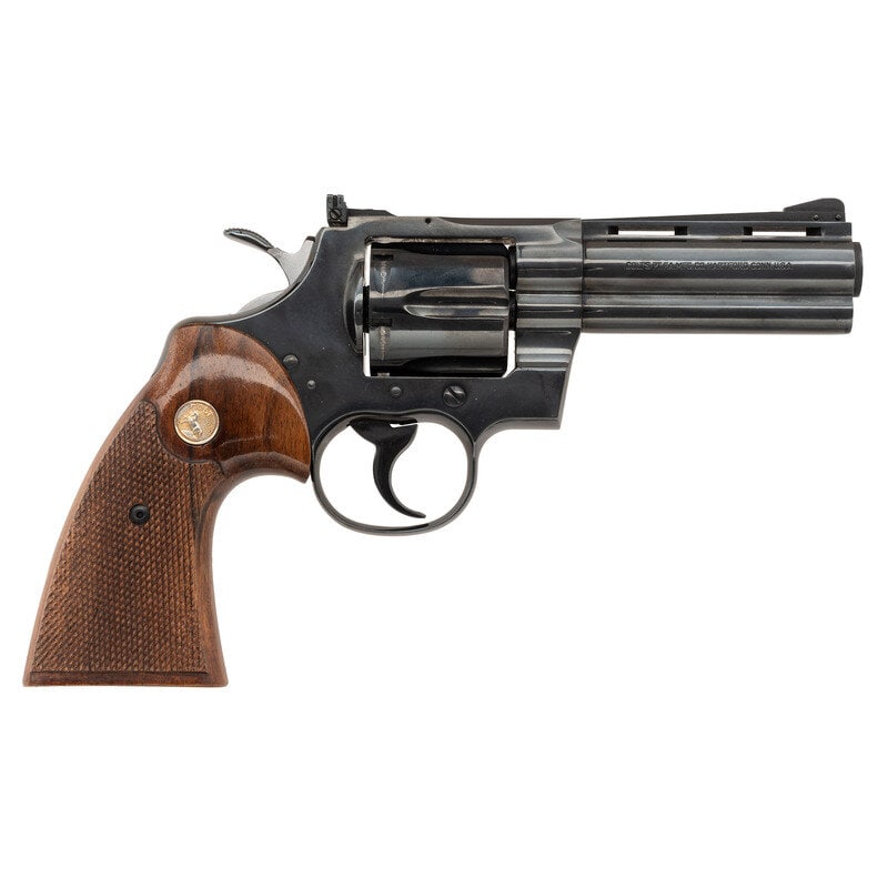 **Colt Python 4 Inch Barrel: **Colt Python 4 Inch Barrel .357 Magnum. 4" barrel length. SN: E25310. Blued metal finish with polished hammer flanks mounting checkered and varnished walnut grips with Colt medallions. Double action 