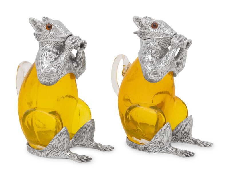A Pair of Silver-Plate and Yellow Glass Squirrel Decanters: A Pair of Silver-Plate and Yellow Glass Squirrel Decanters Height 7 inches x width 4 inches x depth 6 inches. This lot is located in Chicago.
