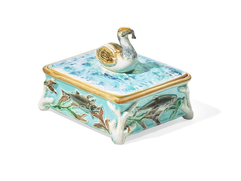 An English Majolica Sardine Box: An English Majolica Sardine Box George Jones, England, Registry Mark for 1874 the sides decorated with fish, seaweed, and coral, the lid with finial in the form of a seagull holding fish. Height 5