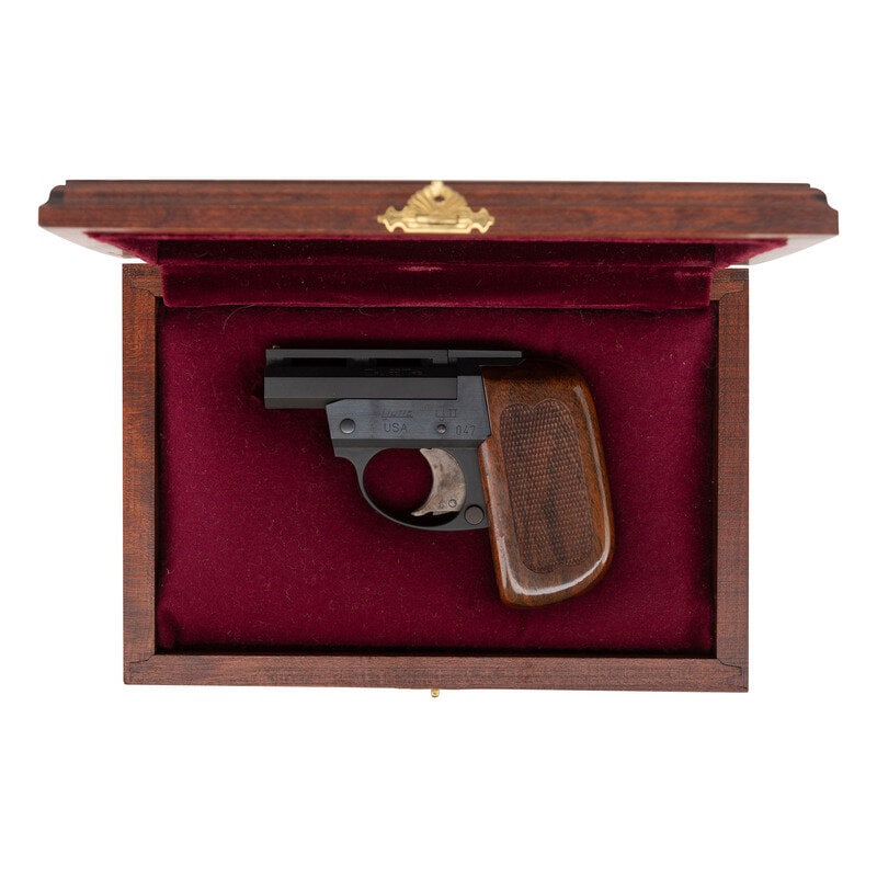 *Cased Ljutic LJ II Derringer with Provenance: *Cased Ljutic LJ II Derringer with Provenance .22 Mag. 2.6875" barrel length. SN: 047. Matte blued metal finish with high polish blued frame flanks mounting one piece checkered walnut grips and case c