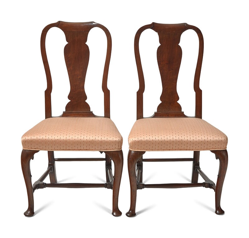 A Pair of George II Walnut Side Chairs: A Pair of George II Walnut Side Chairs Circa 1720 With urn-form splats, on cabriole legs ending in pad feet, joined by stretchers. Height 38 x width 20 3/4 x depth 15 1/2 in. This lot