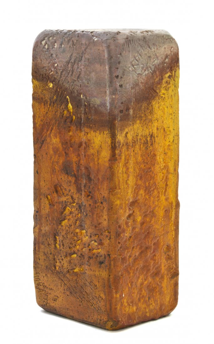 An Italian Pottery Vase, Fantoni for Raymor, Heig: An Italian Pottery Vase, Fantoni for Raymor, of square form with rounded corners, the body having a brown and tan glaze with pitted decoration. Height 13 3/8 inches.