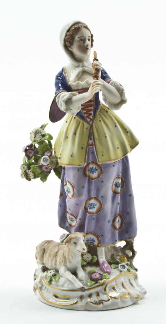 A Capodimonte Porcelain Figure, Height 8 5/8 inch: A Capodimonte Porcelain Figure, depicting a shepherdess playing the flute with a lamb at her side, having a crowned N mark in underglaze blue. Height 8 5/8 inches.