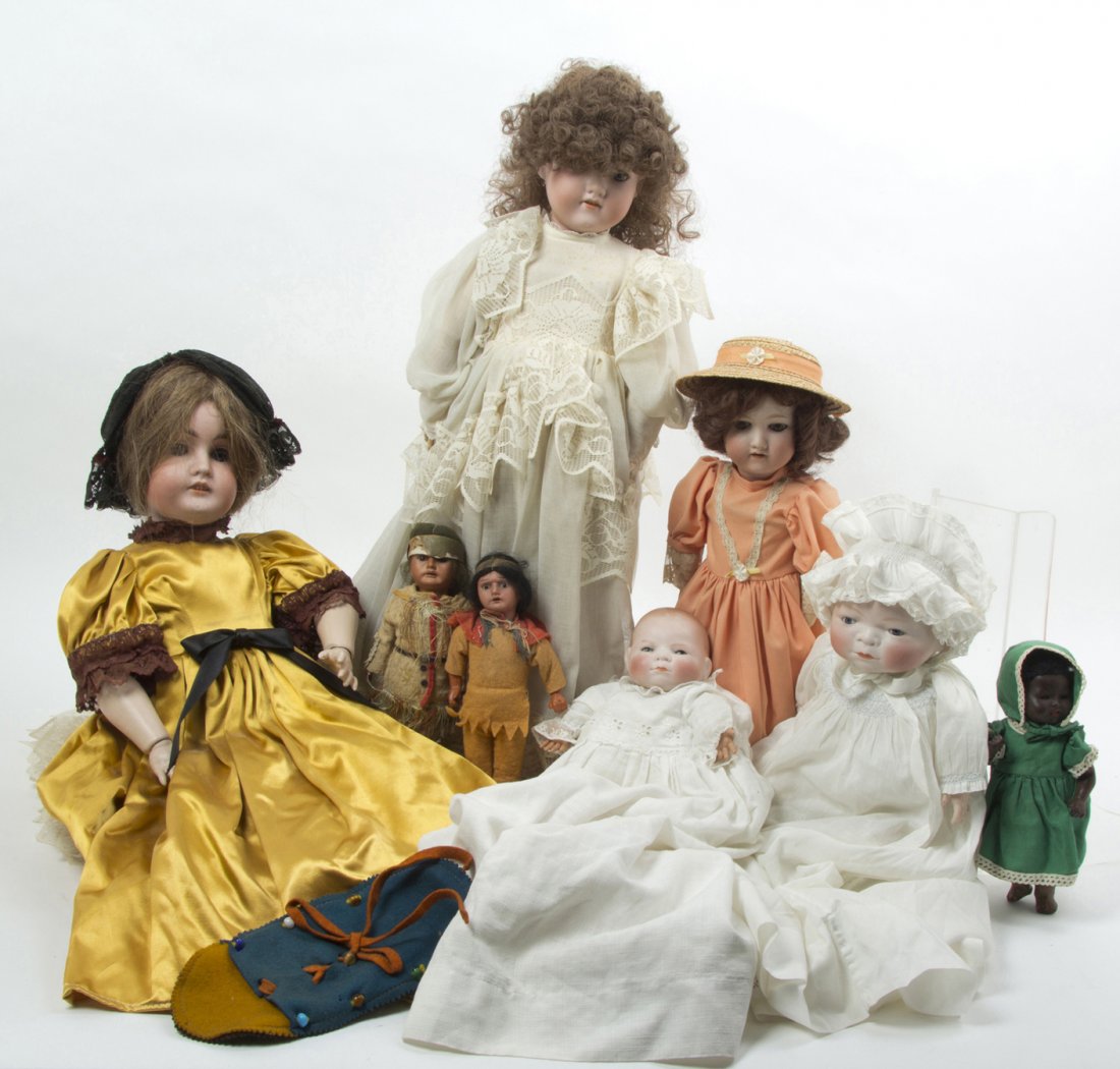 A Group of Seven German Porcelain Dolls, Height o: A Group of Seven German Porcelain Dolls, comprising two babies by Grace S. Putnam each with closed mouths and rocking eyes, two by Armand Marseille, one black example stamped A.M Germany 315-5-OK with