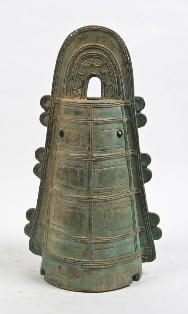 A Chinese Archaistic Bronze Bell, Height 21 1/2 i: A Chinese Archaistic Bronze Bell, having an arched handle over the conical body with raised vertical ribs throughout. Height 21 1/2 inches.