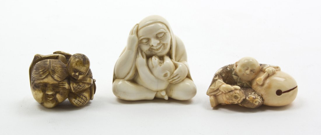 A Group of Three Japanese Carved Ivory Netsuke, H: A Group of Three Japanese Carved Ivory Netsuke, one tea stained depicting a figure with a noh mask, the other a figure with a monkey and the last, a monk sleeping on a Buddhist drum. Height of tallest