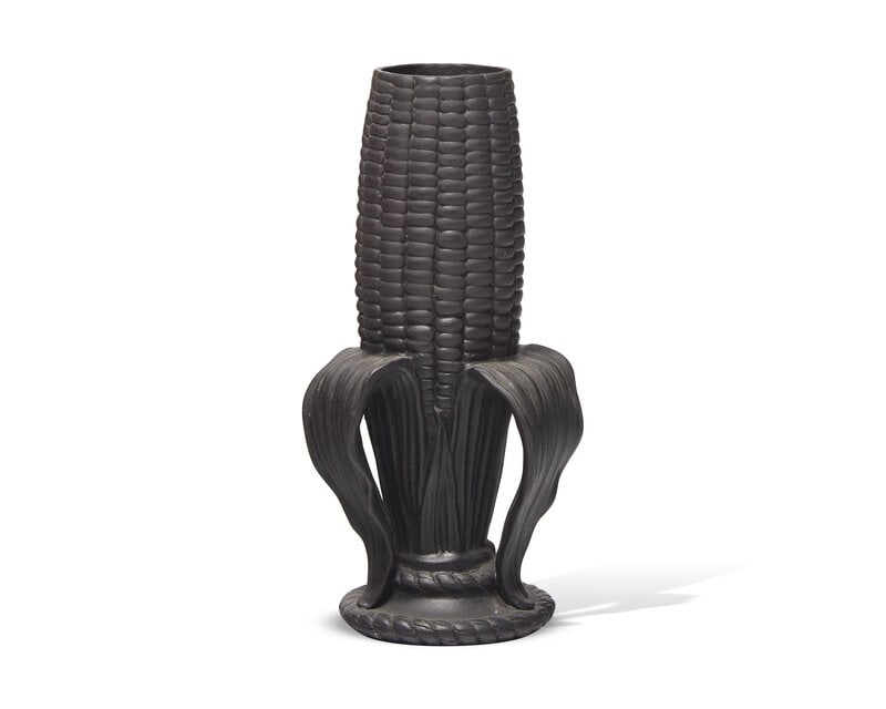 A Wedgwood Black Basalt Cornhusk Bud Vase: A Wedgwood Black Basalt Cornhusk Bud Vase Late 19th Century Modeled partially shucked; impressed Wedgwood stamp, date cypher D for 1875. Height 5 1/4 x width 2 1/2 inches. Prop