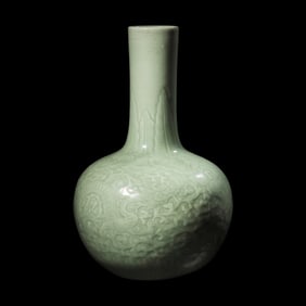 A Chinese Celadon Glazed Molded Porcelain Bottle Vase, Late Qing Dynasty 清晚期
