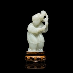 A Chinese Pale Celadon Jade Figure of a Boy, 18th-19th Century 清中期 青