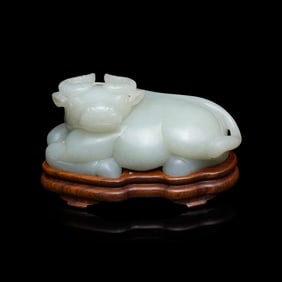 A Chinese Pale Celadon Jade Figure of a Recumbent Buffalo, Qing Dynasty 清 青玉