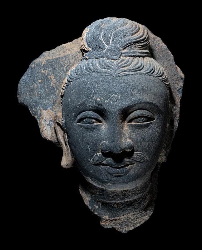 A Gandharan Grey Schist Head of Buddha (1 of 3)