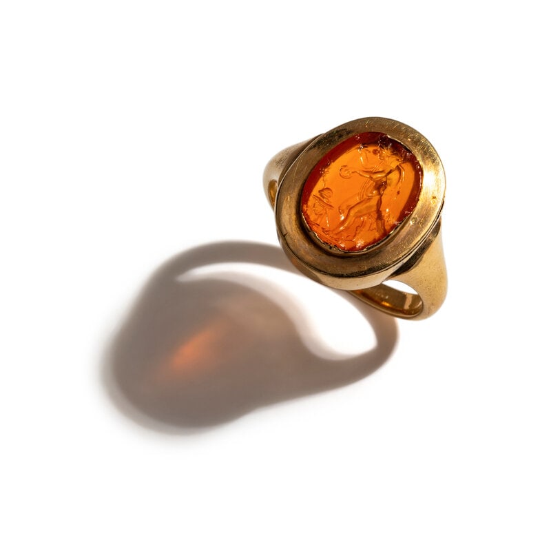 A Neoclassical Gold and Carnelian Finger Ring with the Goddess Ceres at an Alter: A Neoclassical Gold and Carnelian Finger Ring with the Goddess Ceres at an Alter Ring size 6 3/4; 18 karat gold; 3.38 dwt. Size Ring size 6 3/4; 18 karat gold; 3.38 dwt. Pr