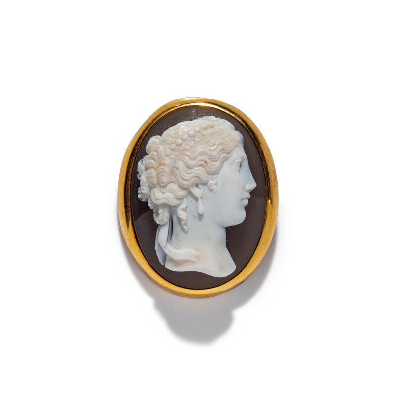 A Neoclassical Gold and Sardonyx Cameo Brooch with a Portrait Head of a Goddess: A Neoclassical Gold and Sardonyx Cameo Brooch with a Portrait Head of a Goddess Height 1 3/4 inches (4.45 cm); 18 karat gold; 21.89 dwt. Property from a New York Private Collection Size<
