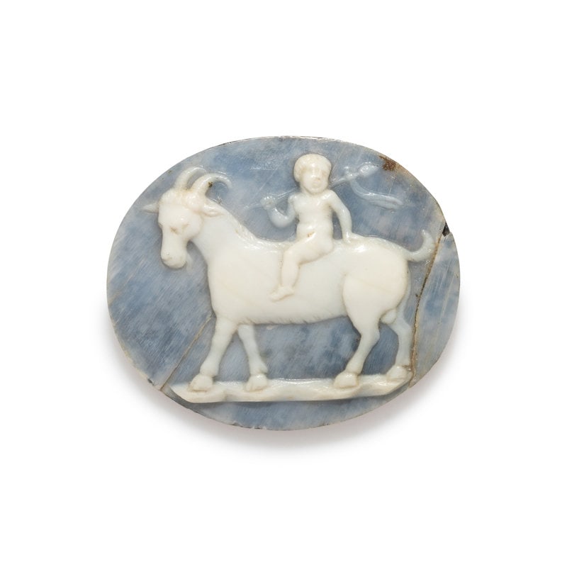A Neoclassical Shell Cameo with the Infant Dionysos Riding a Goat: A Neoclassical Shell Cameo with the Infant Dionysos Riding a Goat Length 1 1/16 inches (2.7 cm). Size Length 1 1/16 inches (2.7 cm).