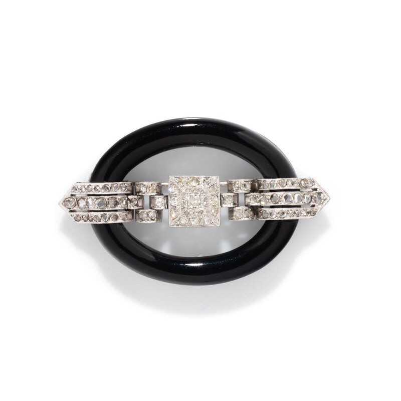 ART DECO, ONYX AND DIAMOND BUCKLE BROOCH: ART DECO, ONYX AND DIAMOND BUCKLE BROOCH Black onyx and old mine and rose cut diamonds. Platinum and white gold. 2 1/4 x 1 3/8 inches. Gross weight: 11.20 dwt. From the Private Collec