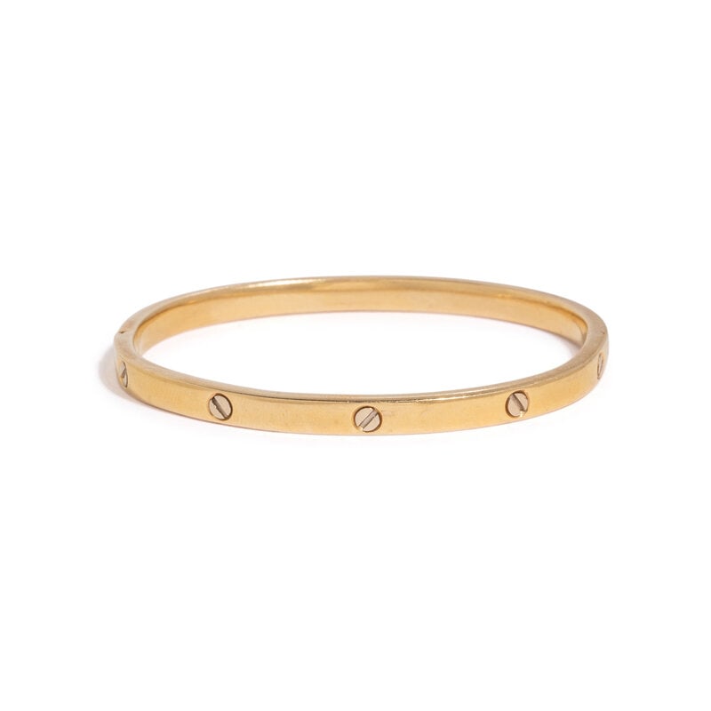 YELLOW GOLD BANGLE BRACELET : YELLOW GOLD BANGLE BRACELET Hinged with side clasp. 18 karat yellow gold. 7 inches inner circumference. Stamp: 750. Gross weight: 10.30 dwt. Condition Overall Co