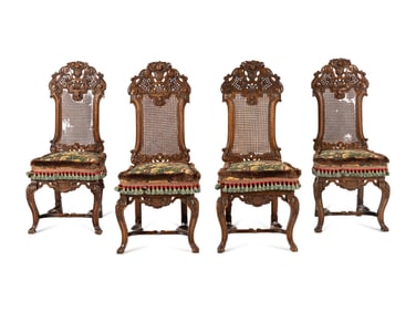 A Set of Four William and Mary Style Caned and Pierced-Carved Walnut Dining Chairs