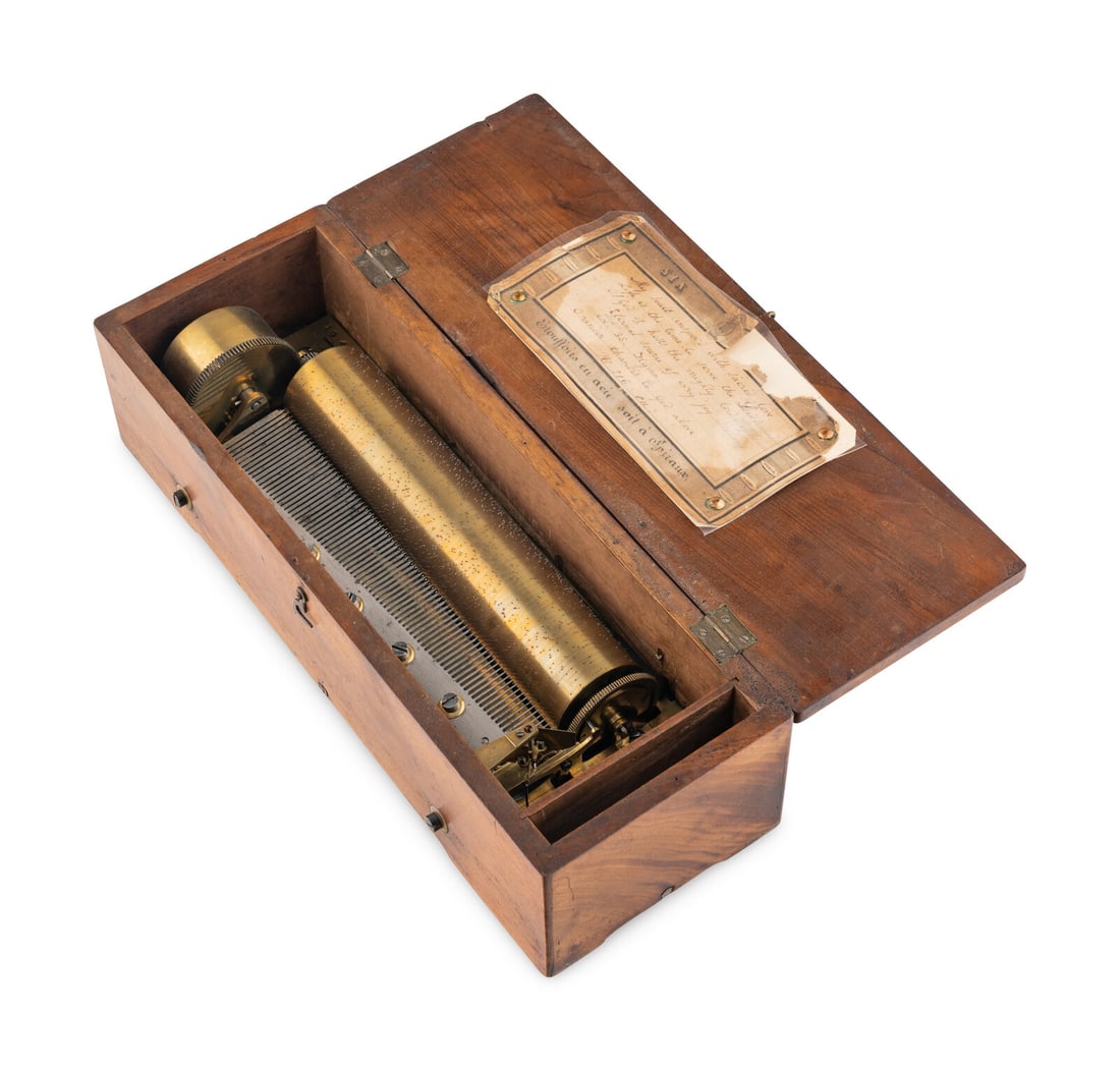 A Key Wind Six-Air Music Box by Ducommun Girod: A Key Wind Six-Air Music Box by Ducommun Girod serial no. 10451, with an 8 1/4 inch cylinder, tune card and fruitwood case with exposed controls. Height 4 x width 13 1/2 x depth 5 inches. Property fro