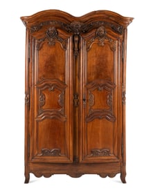 A Louis XV Carved Walnut Armoire