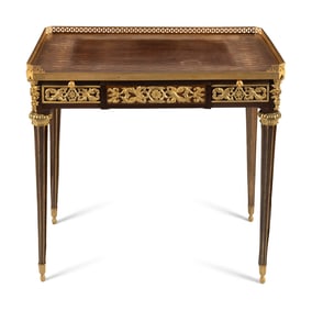 A Louis XVI Style Gilt Bronze Mounted Mahogany and Parquetry Table