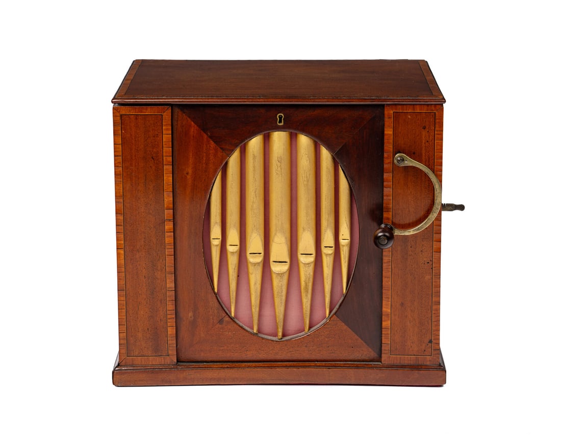 A Table Barrel Organ by Flight and Co.: A Table Barrel Organ by Flight and Co. London, 1785 with twelve key mechanism, twelve wood pipes and eight tune eight inch barrel, in mahogany case, with tune sheet in lid and false pipe front. Height
