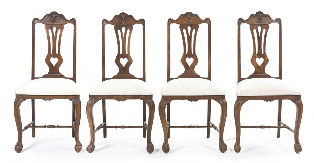 A Set of Four Spanish Walnut Side Chairs, Height 43 : A Set of Four Spanish Walnut Side Chairs, 19th/20th century, each having a carved shell crest rail over a pierced vertical splat, above the upholstered seat, raised on carved cabriole legs ending in c