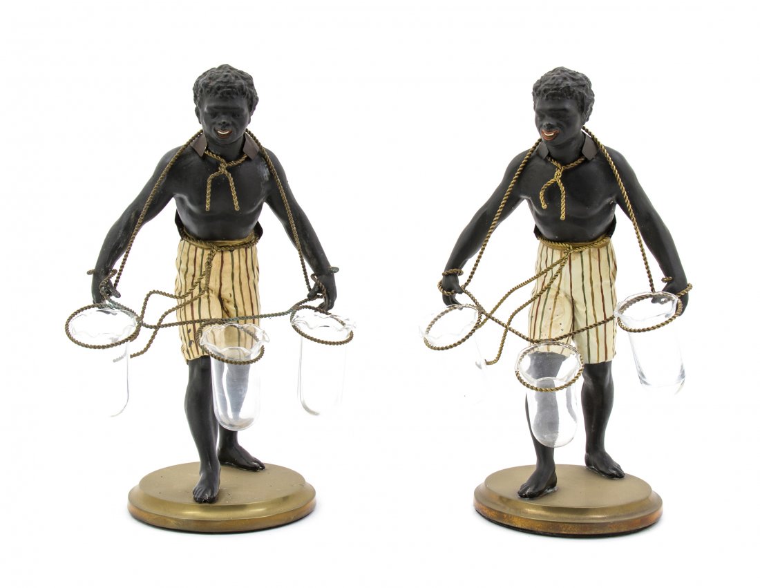 A Pair of Cast Metal Figural Tulipieres, Height 13 : A Pair of Cast Metal Figural Tulipieres, each in the form of a standing blackamoor holding ropes with glass liners. Height 13 inches. Property from the Collection of Mr. and Mrs. William E. Benjamin I