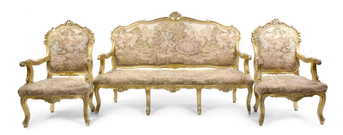 A Louis XV Style Giltwood Parlor Suite, Width of f: A Louis XV Style Giltwood Parlor Suite, comprising a canape and two fauteuils, each having a tapestry upholstered back, arms and seat, within the foliate carved frames, raised on cabriole legs. Width 