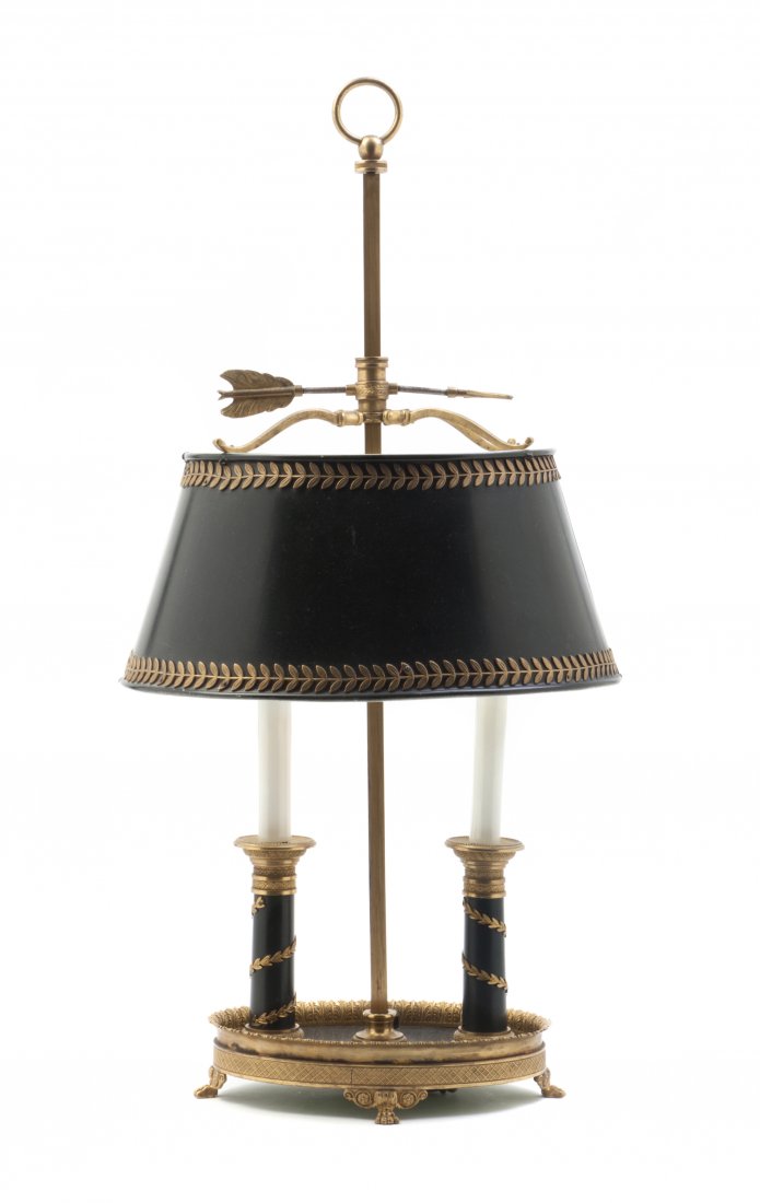 A Louis XVI Style Gilt and Patinated Bronze Bouill: A Louis XVI Style Gilt and Patinated Bronze Bouillotte Lamp, having a ring handle and an oval tole shade, raised on a conforming base with two candle form lighting elements. Height overall 23 inches. 