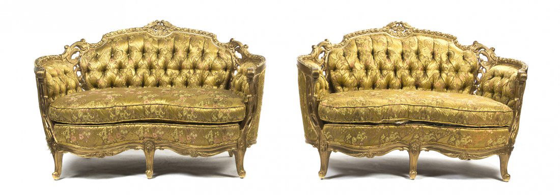 A Pair of Louis XVI Style Giltwood Settees, Width: A Pair of Louis XVI Style Giltwood Settees, each having pierce carved bird and foliate decorated crests over the upholstered tufted back, arms and seat, raised on cabriole legs ending in scrolled toes
