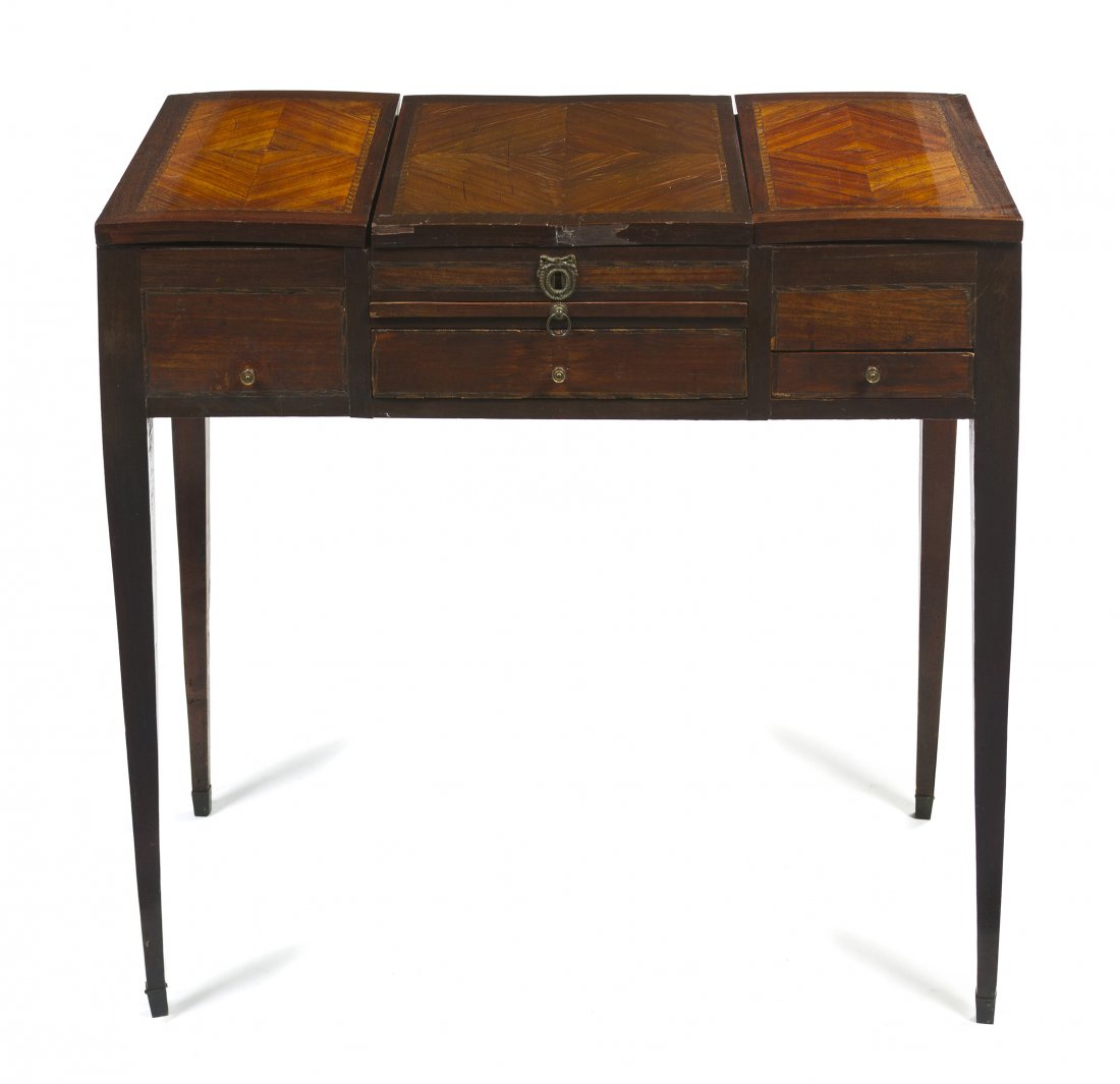 A Continental Mahogany Poudresse, Height 29 x widt: A Continental Mahogany Poudresse, having a central hinged lift mirror flanked by two compartments, the case further set with two drawers and a dressing slide, raised on square tapering legs. Height 29