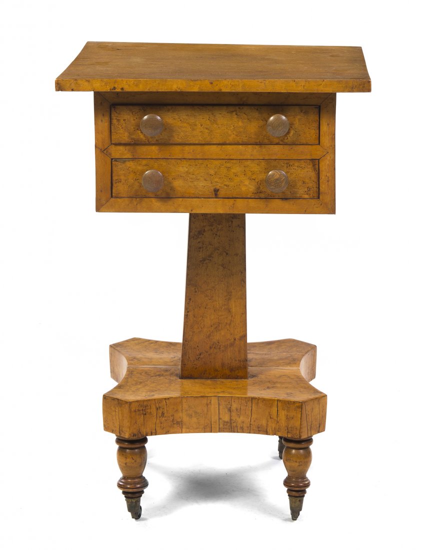 A Biedermeier Occasional Table, Height 29 x width : A Biedermeier Occasional Table, having a rectangular top over two drawers, raised on a tapering square standard, the whole set on casters. Height 29 x width 19 1/2 x depth 19 inches. Property from the