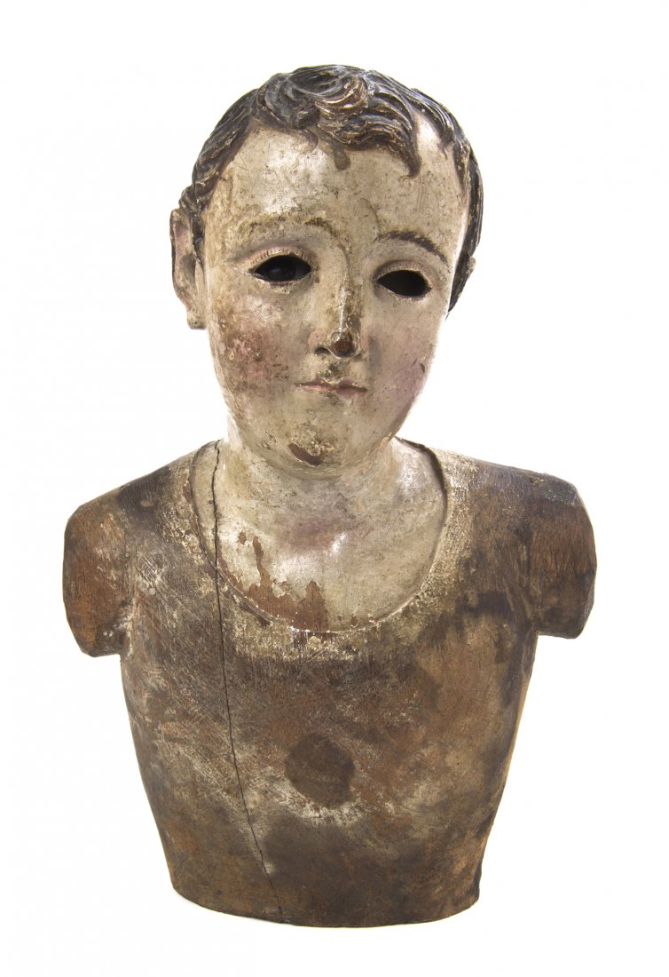 A Continental Carved and Polychrome Decorated Bust: A Continental Carved and Polychrome Decorated Bust, depicting a boy, having one glass eye. Height 9 1/4 inches. Property from the Estate of Mr. Mark Fritz, West Bloomfield, Michigan