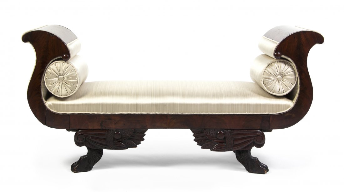 An American Classical Mahogany Window Bench, Width: An American Classical Mahogany Window Bench, having rounded arms over the upholstered seat, raised on winged paw feet. Width 61 inches. Property from the Estate of Evelyn Stefani, Inverness, Illinois