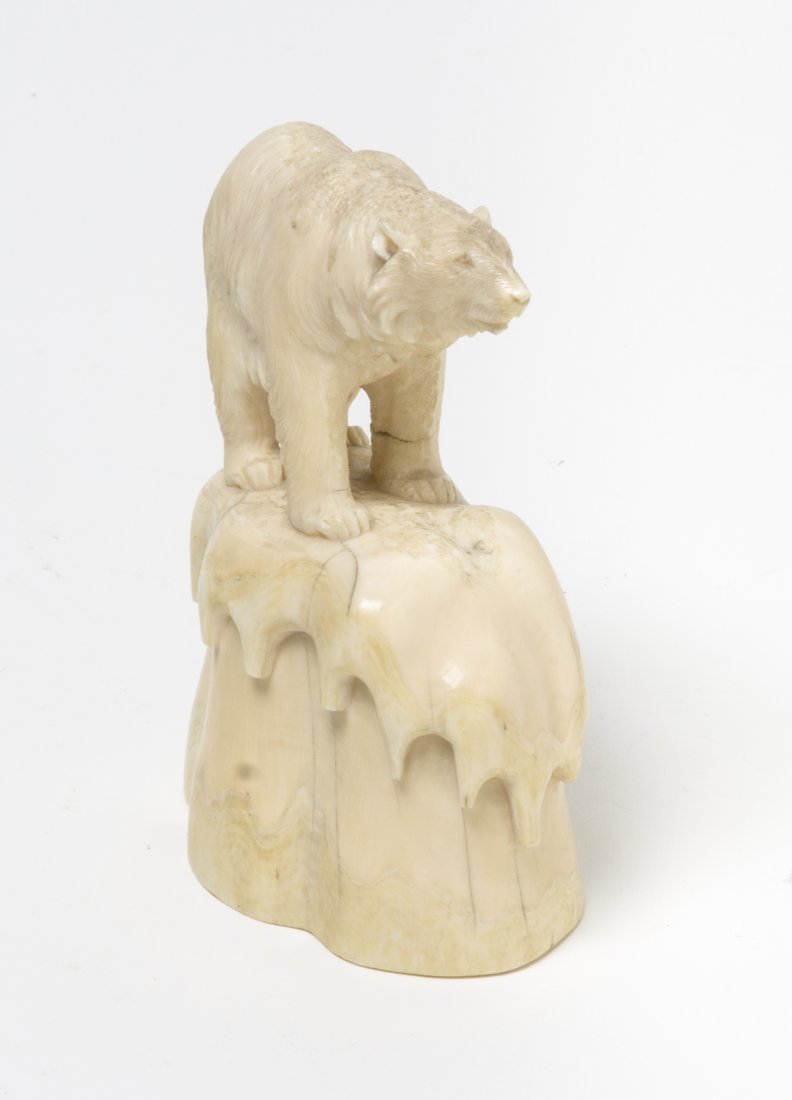 A Marine Ivory Carving of a Polar Bear, Height 4 1: A Marine Ivory Carving of a Polar Bear, the animal depicted on a naturalistic base capped in melting snow. Height 4 1/2 inches.