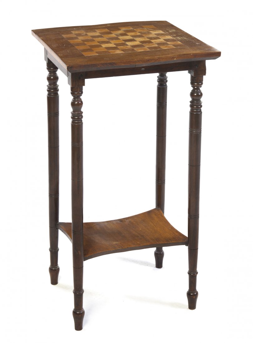 A Victorian Walnut Games Table, Height 29 x width : A Victorian Walnut Games Table, the square top having an inlaid chessboard, raised on turned legs joined by a medial shelf. Height 29 x width 16 x depth 16 inches. Property from the Estate of Mr. Mark